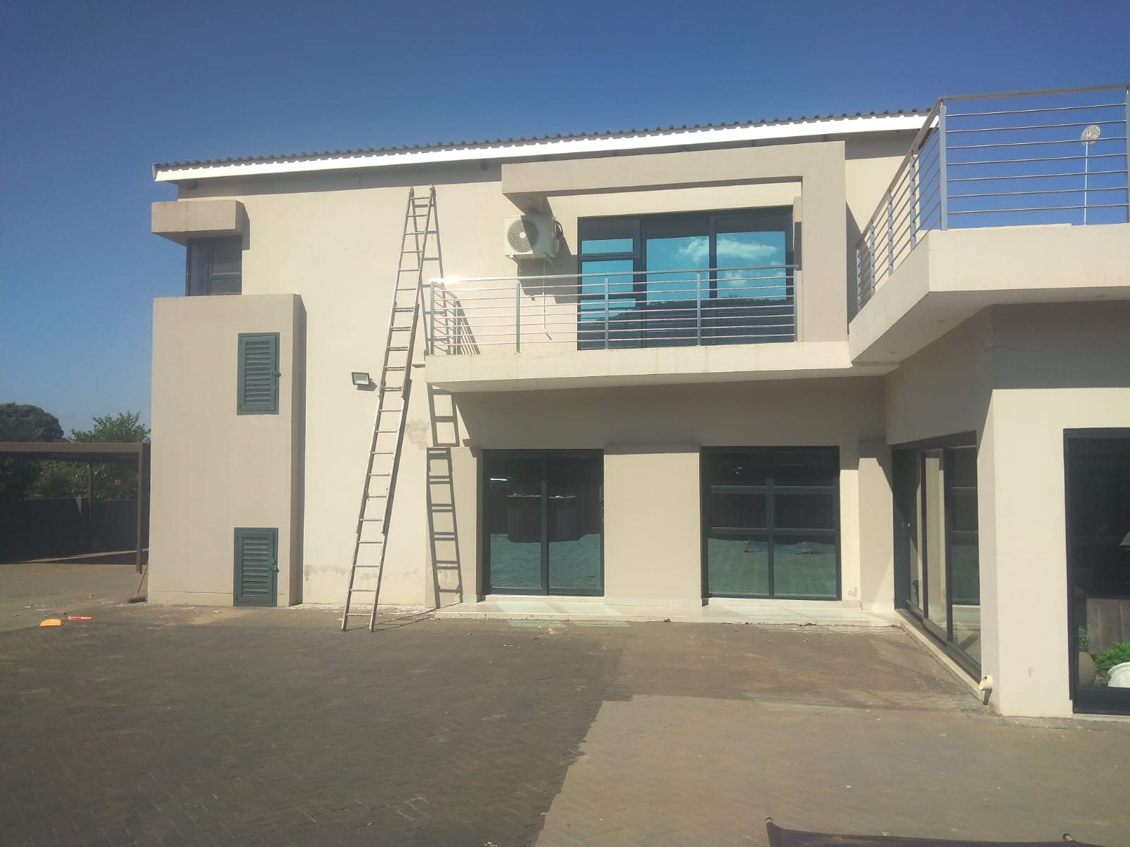 House exterior before painting with faded cream walls