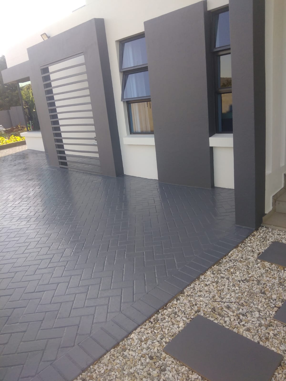 Paved driveway after coating with glossy charcoal finish