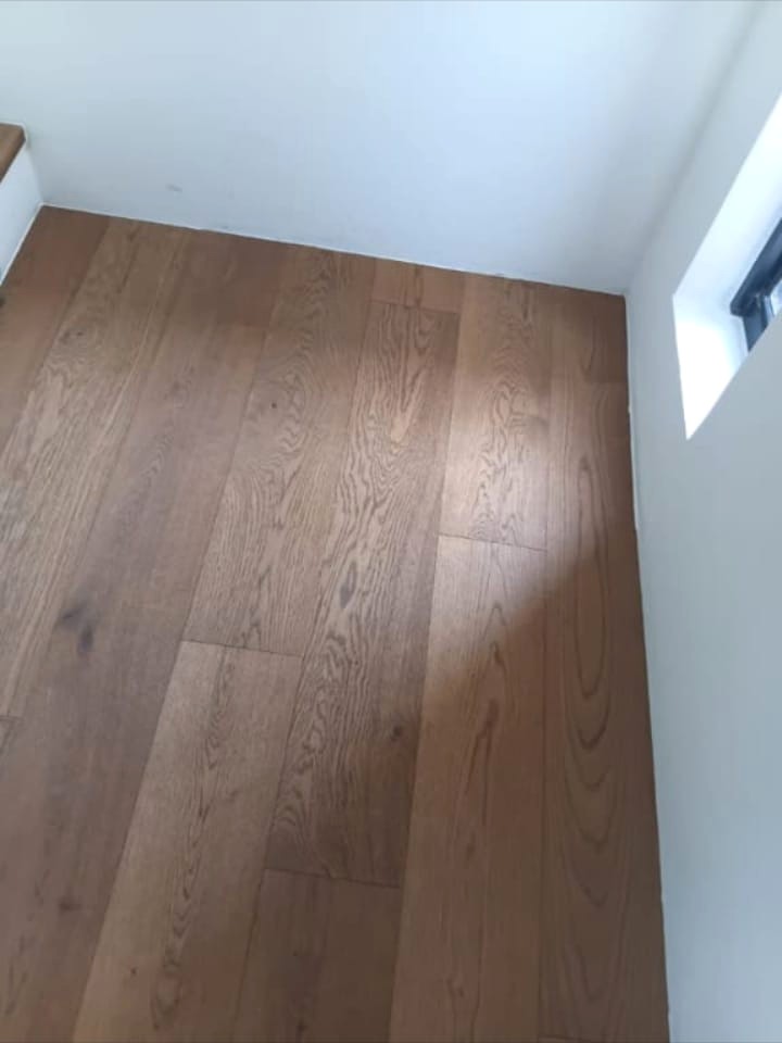 Warm natural wooden floor installed on an upstairs landing